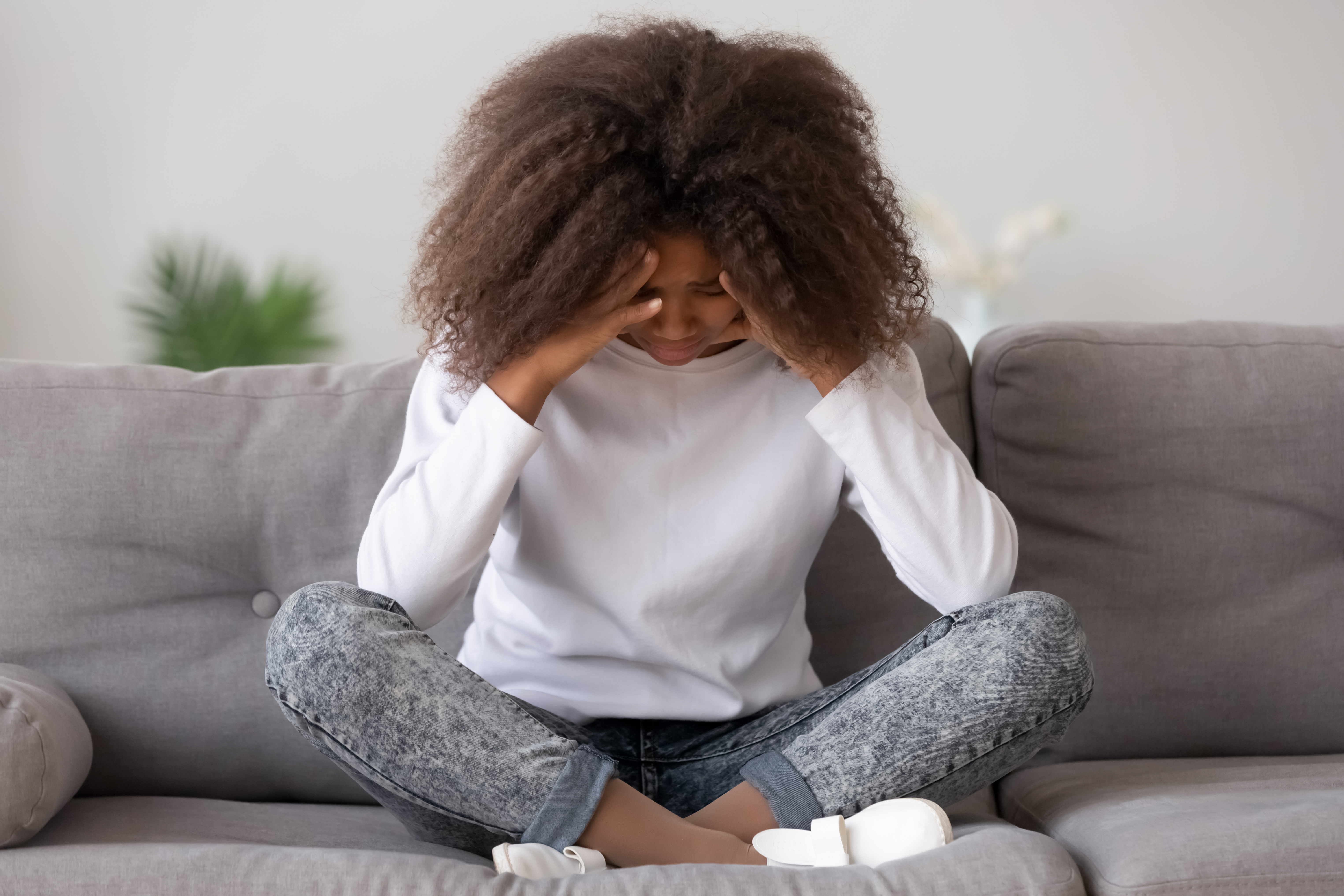 Depressed upset african american teen girl feeling hurt sitting alone | Youth suicide